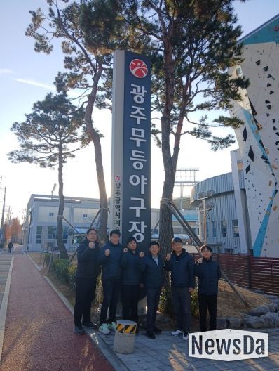 나성현 무등팀장 등 직원들이 무등야구장 앞에서 파이팅을 외치고 있다.